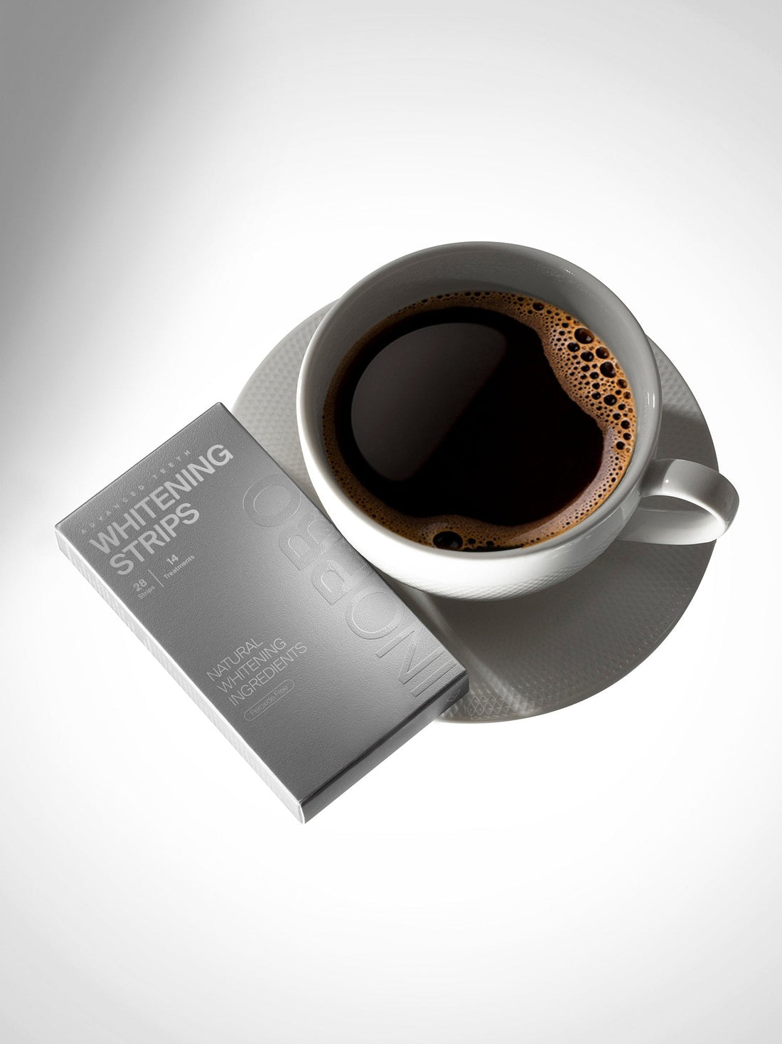 INOPRO whitening strips beside a cup of coffee