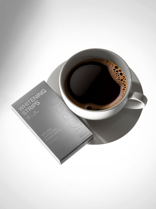 INOPRO whitening strips beside a cup of coffee