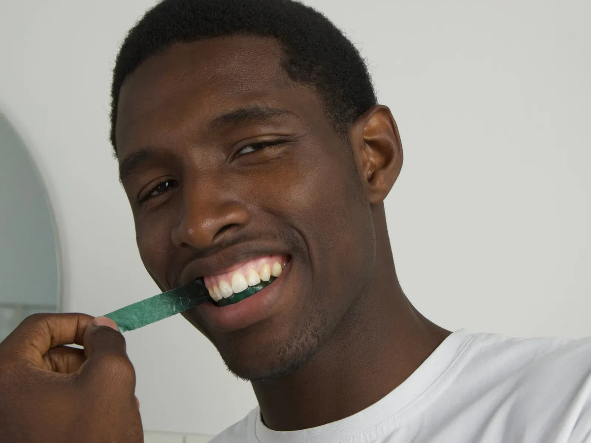 Man applying an Innovative whitening strip