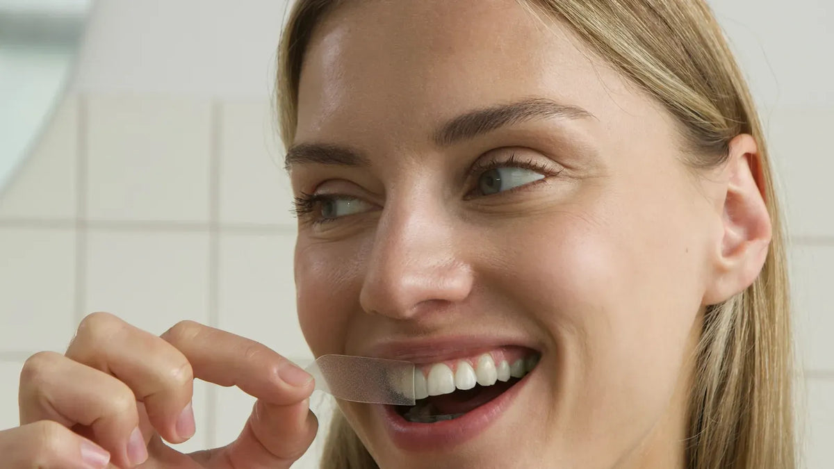 Model applying a clear INOPRO whitening strip