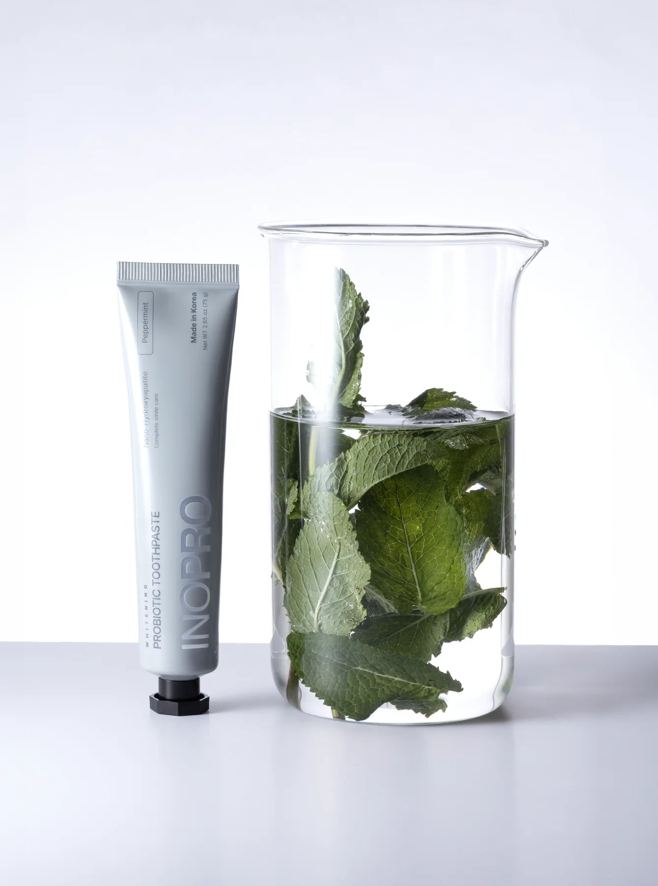 Peppermint toothpaste with a mint-inspired still life